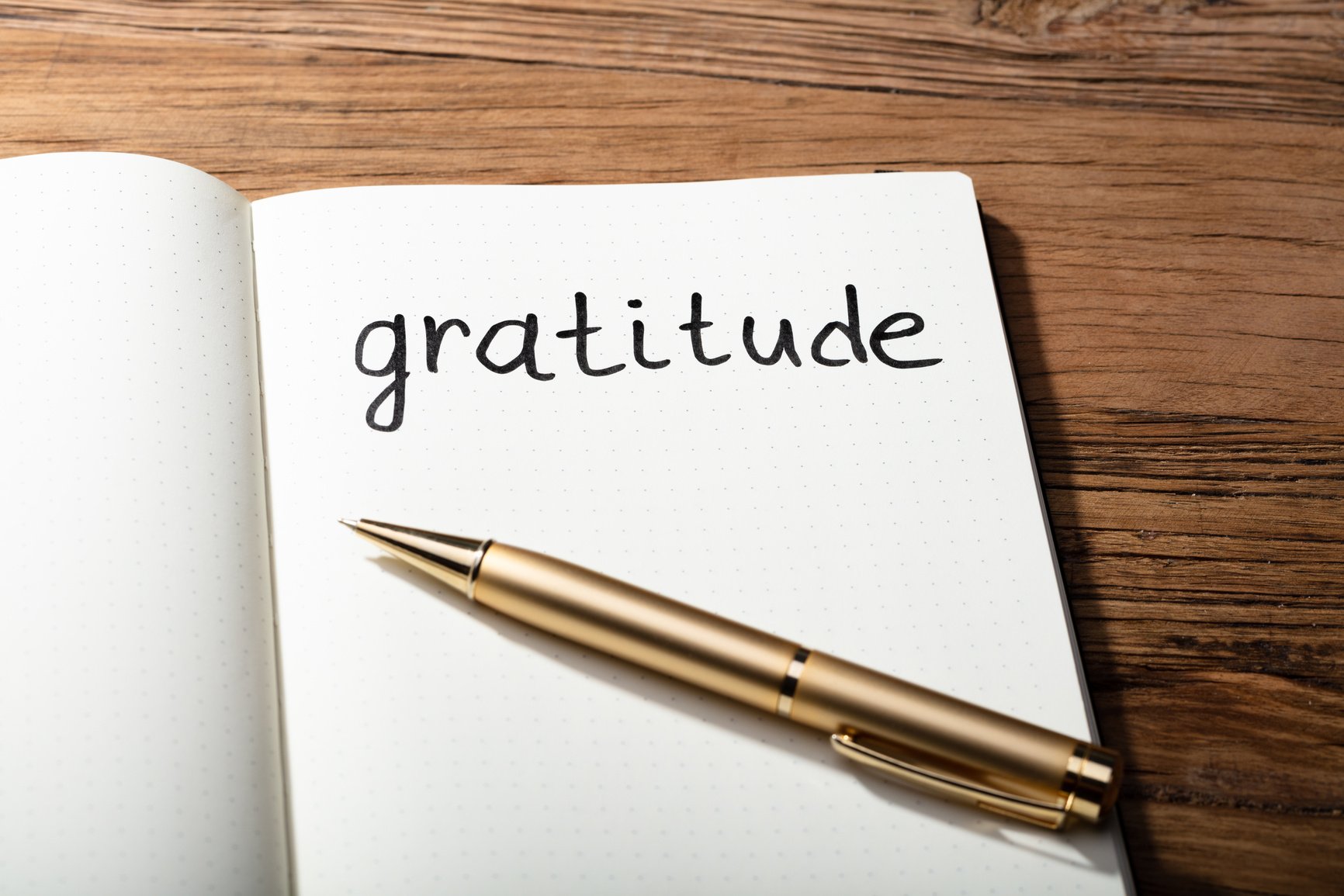 Gratitude Word With Pen On Notebook