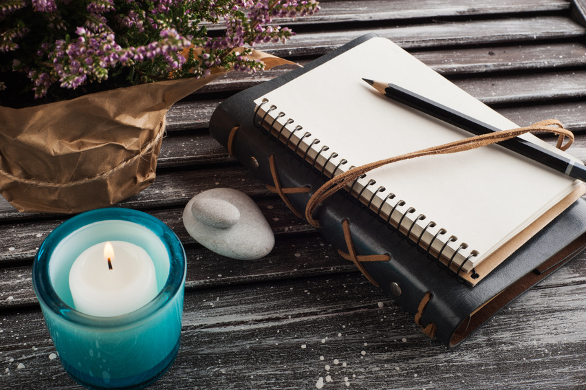Empty Journal, Heather Flowers, Candles and Pebbles